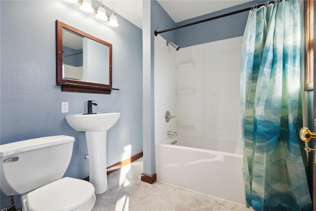 full bathroom with toilet, shower / tub combo with curtain, and sink