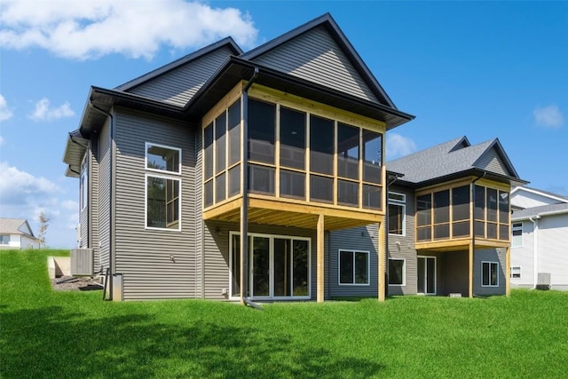 back of house featuring central AC, a lawn, and a sunroom