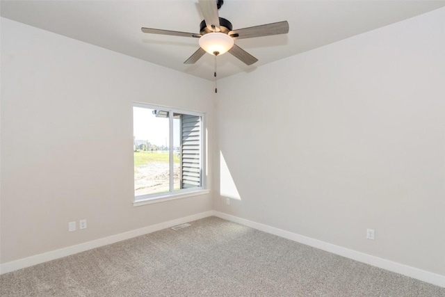 carpeted spare room featuring ceiling fan