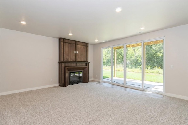 unfurnished living room featuring light carpet