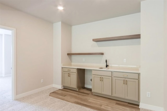 kitchen featuring light colored carpet and sink