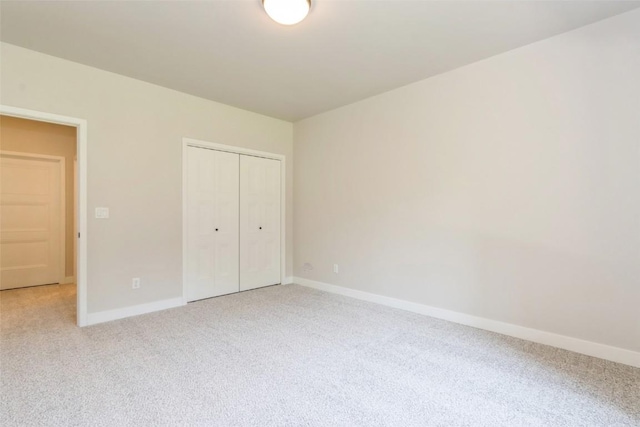 unfurnished bedroom with carpet floors and a closet