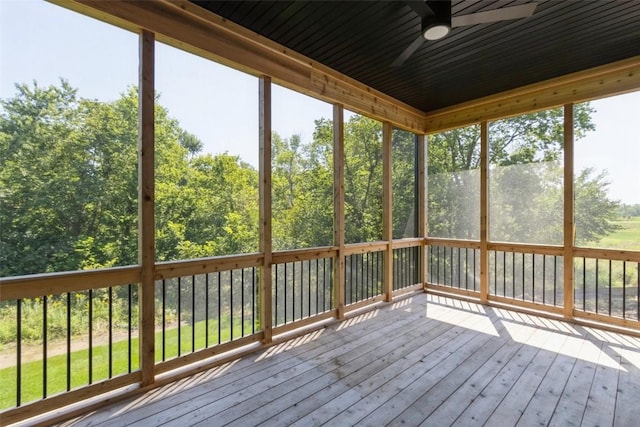 unfurnished sunroom featuring ceiling fan