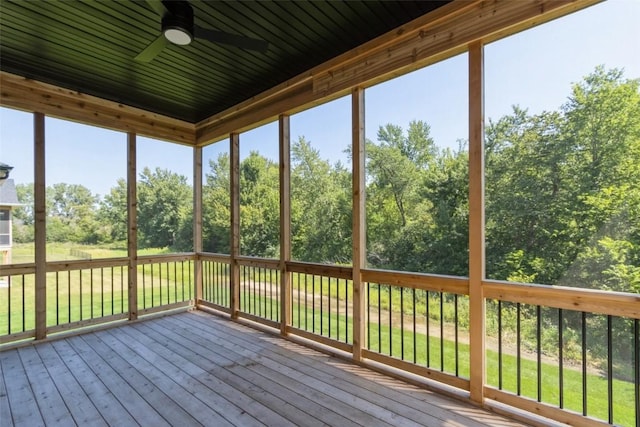 unfurnished sunroom with ceiling fan