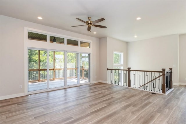 unfurnished room with ceiling fan and light hardwood / wood-style floors