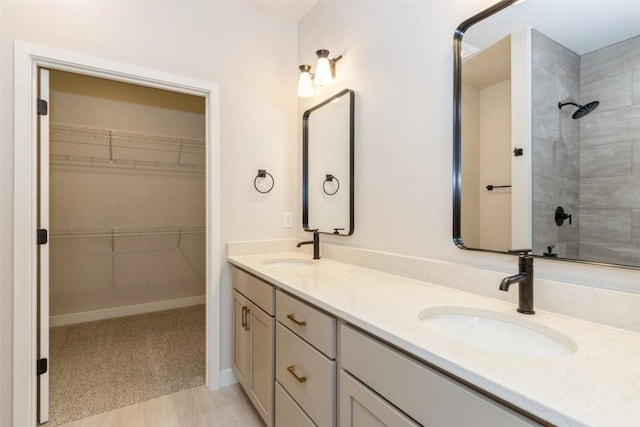 bathroom featuring walk in shower, tile patterned flooring, and vanity