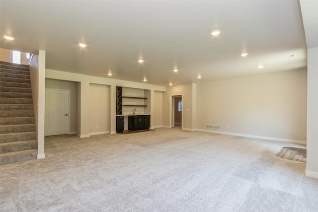 unfurnished living room featuring light carpet