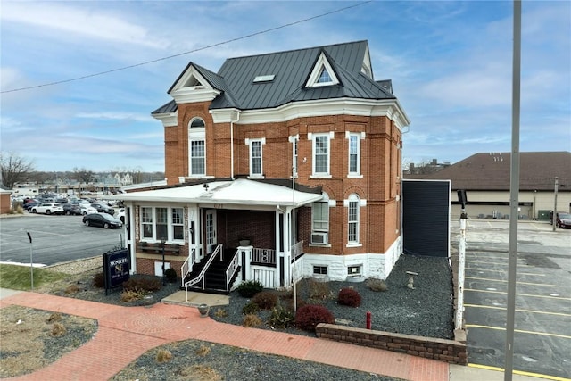 view of front of property with covered porch and cooling unit