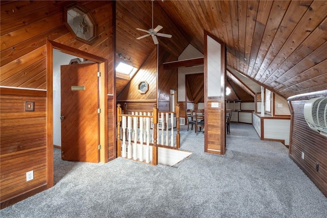 bonus room with ceiling fan, wood ceiling, a skylight, and wood walls