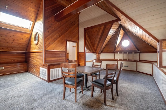 unfurnished dining area with wooden ceiling, wooden walls, carpet flooring, and vaulted ceiling with skylight