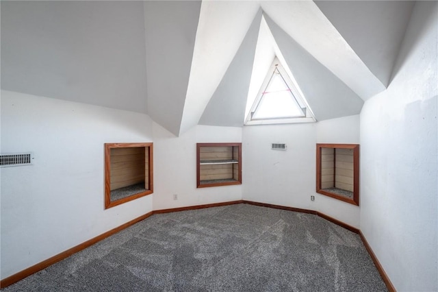 additional living space with vaulted ceiling and carpet