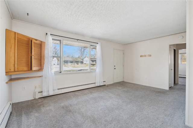 empty room with baseboard heating, a textured ceiling, and light carpet