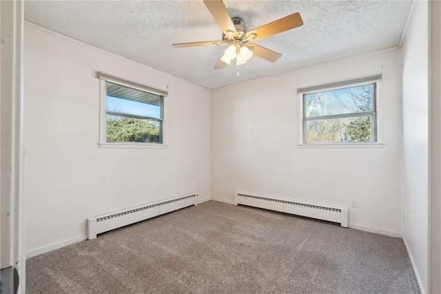 unfurnished room with a textured ceiling, a baseboard radiator, and plenty of natural light