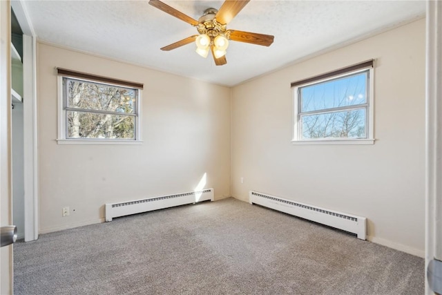 carpeted empty room featuring baseboard heating and ceiling fan