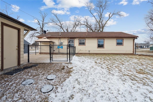 view of snow covered rear of property