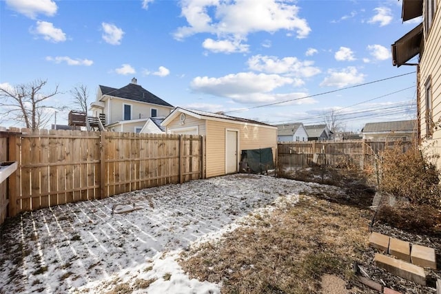 snowy yard featuring an outdoor structure