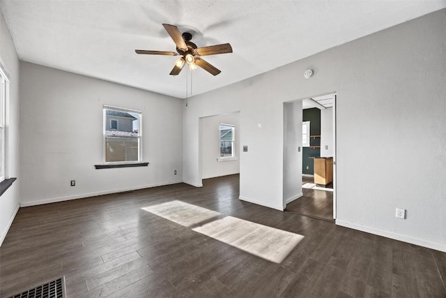 spare room with ceiling fan and dark hardwood / wood-style flooring