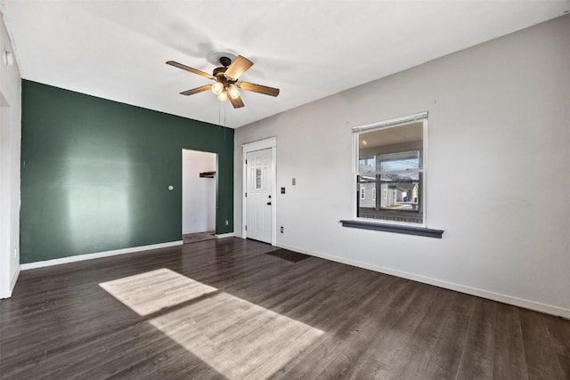 unfurnished room featuring ceiling fan and dark hardwood / wood-style floors