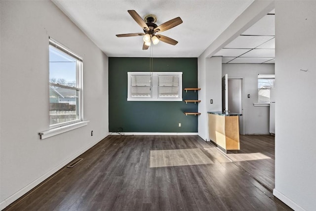 unfurnished room with ceiling fan and dark hardwood / wood-style flooring