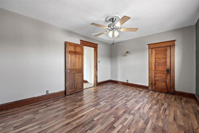 unfurnished bedroom with ceiling fan and dark hardwood / wood-style flooring