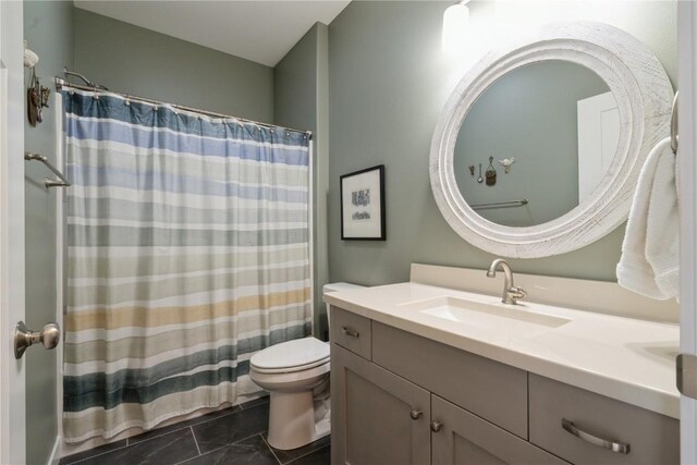 bathroom featuring toilet, tile patterned flooring, and vanity