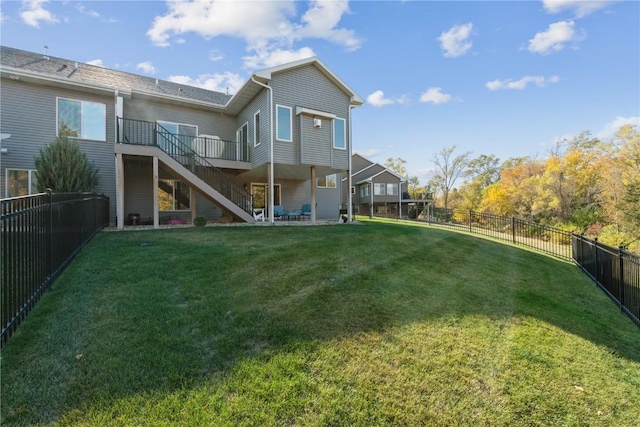 rear view of house featuring a yard