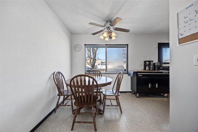 dining area with a textured ceiling and ceiling fan