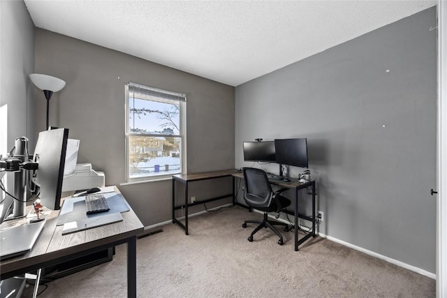 office area with a textured ceiling and carpet floors