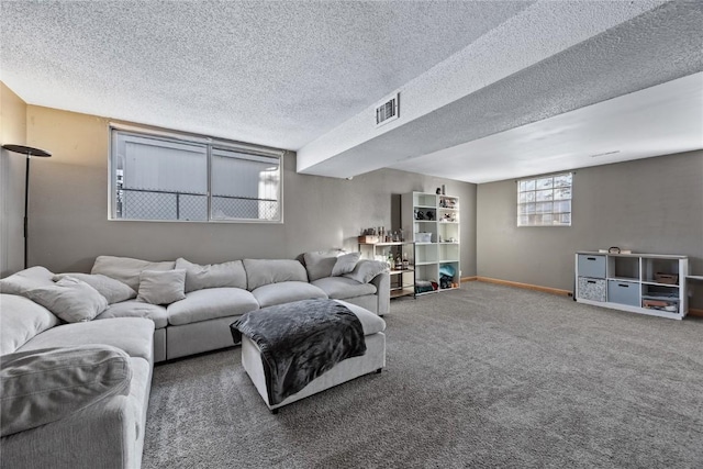 living room with a textured ceiling and carpet flooring