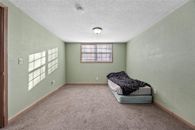 unfurnished bedroom featuring carpet floors and a textured ceiling