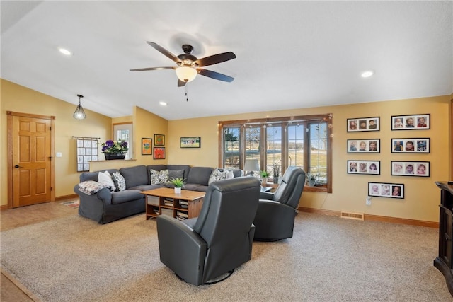 living room featuring ceiling fan, light colored carpet, and vaulted ceiling