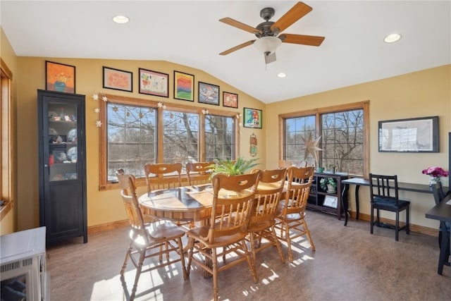 dining space featuring ceiling fan and lofted ceiling