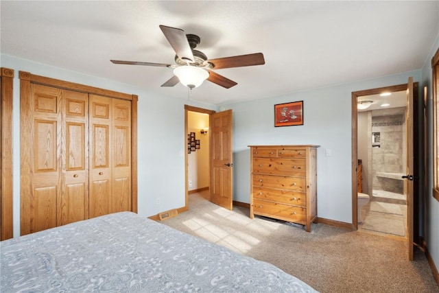 bedroom featuring connected bathroom, a closet, ceiling fan, and light colored carpet