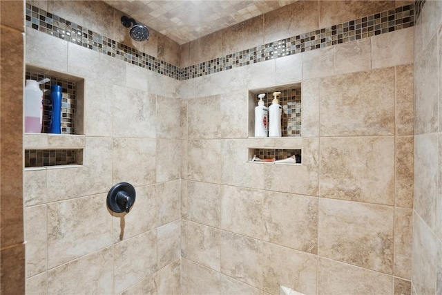 bathroom with a tile shower