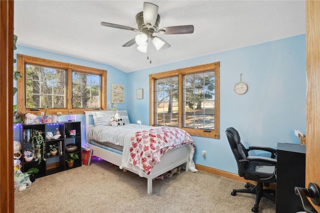 carpeted bedroom featuring ceiling fan and vaulted ceiling