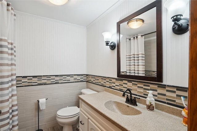 bathroom featuring toilet, crown molding, and vanity