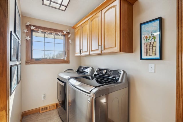 laundry room with cabinets and independent washer and dryer