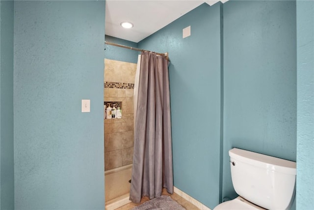 bathroom with walk in shower and toilet