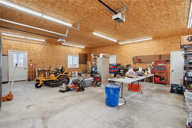 garage featuring a garage door opener and a workshop area