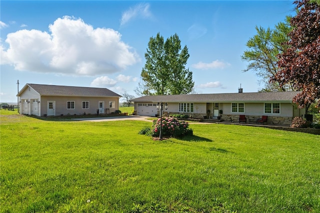 1394 210th St, Tipton, IA 52772 - single story home featuring asphalt driveway, an attached garage, stone siding, and a front lawn
