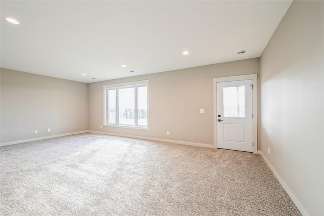 carpeted spare room with a healthy amount of sunlight