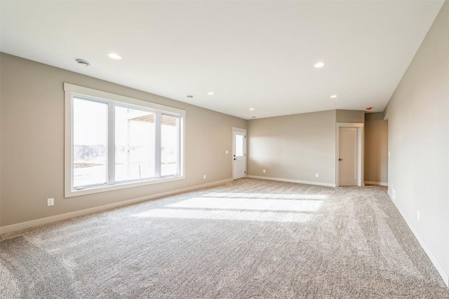 618 J Ave NE, Cedar Rapids, IA 52402 - unfurnished room featuring light carpet, baseboards, and recessed lighting