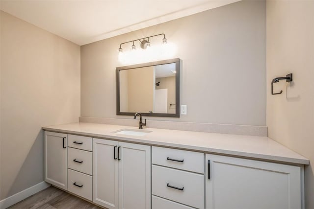 bathroom featuring hardwood / wood-style flooring and vanity