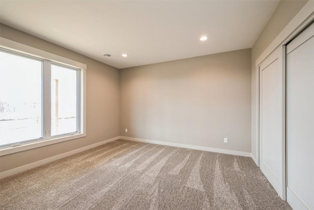 618 J Ave NE, Cedar Rapids, IA 52402 - unfurnished bedroom featuring carpet flooring, baseboards, recessed lighting, and a closet