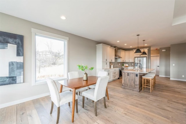 dining area featuring light hardwood / wood-style floors and sink