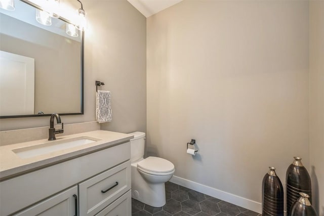 bathroom with toilet, tile patterned floors, and vanity