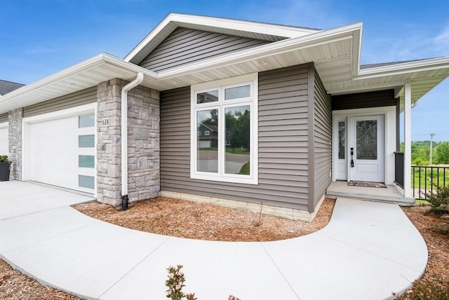 618 J Ave NE, Cedar Rapids, IA 52402 - property entrance with a garage and concrete driveway