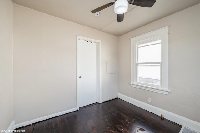 spare room featuring ceiling fan and dark hardwood / wood-style flooring