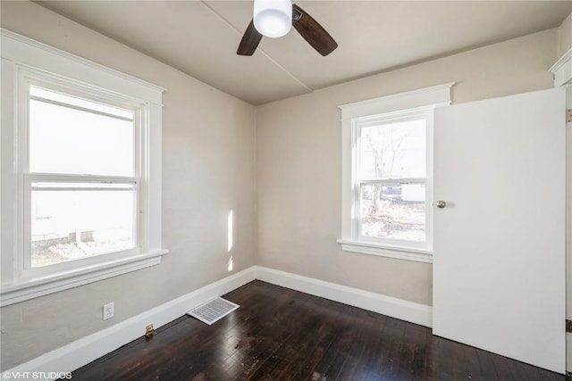 unfurnished room featuring ceiling fan and dark hardwood / wood-style floors