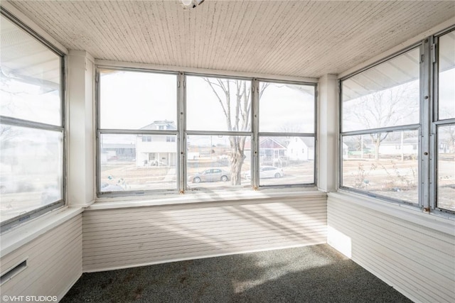 unfurnished sunroom featuring wooden ceiling